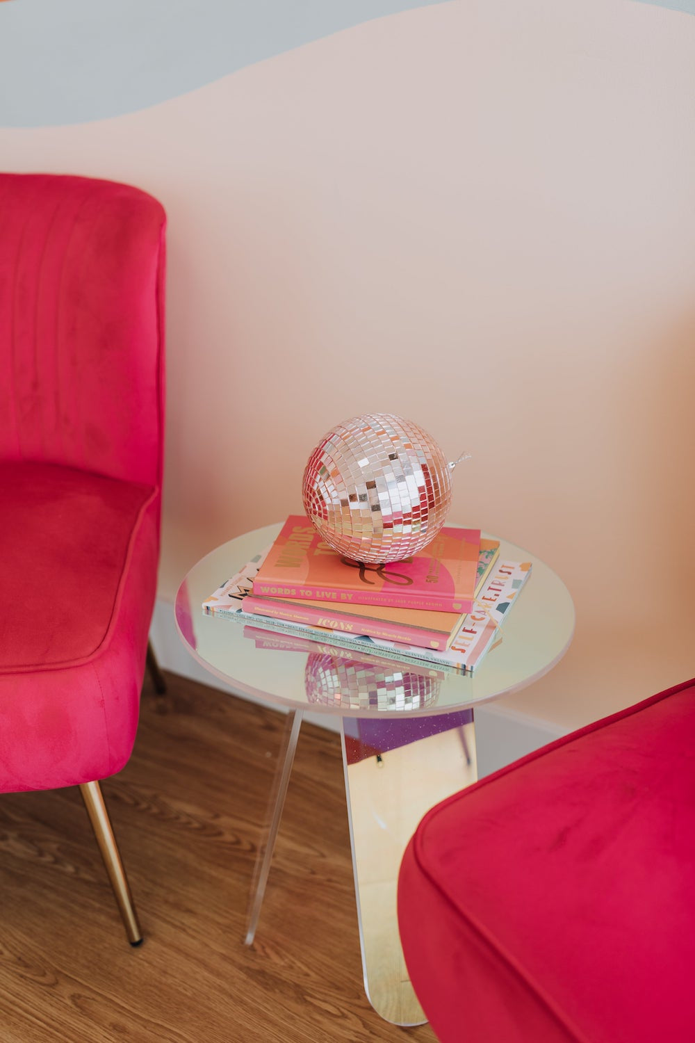 pink chair and glass side table with books, esthetician in Phoenix